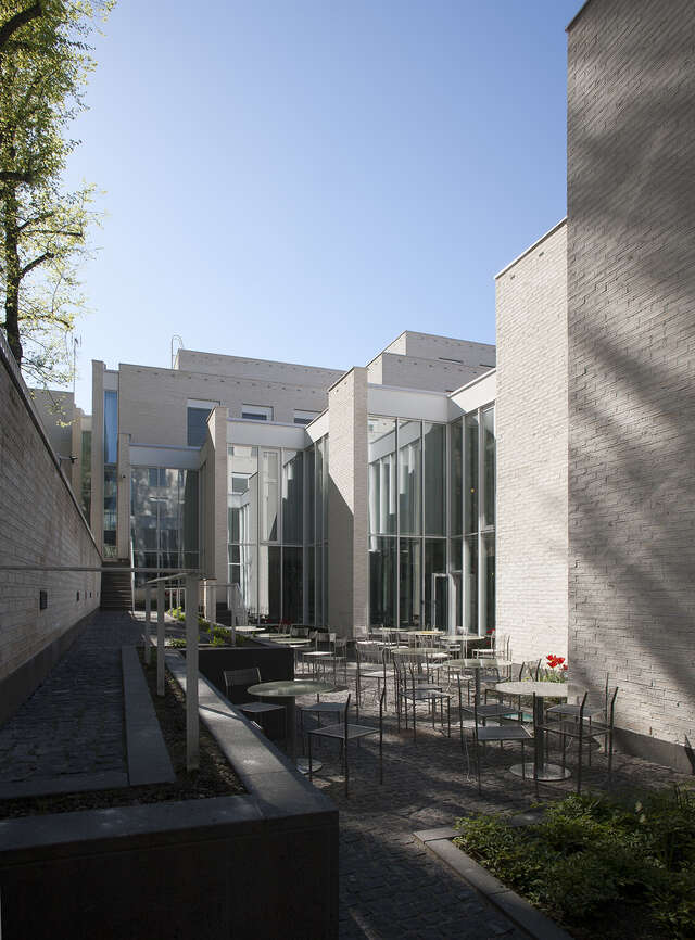 Inner courtyard with outdoor dining tables and planters.