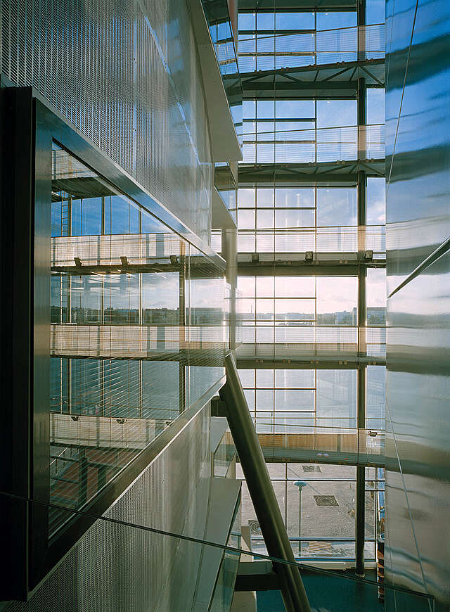Glass wall in an open space viewed from the third storey.