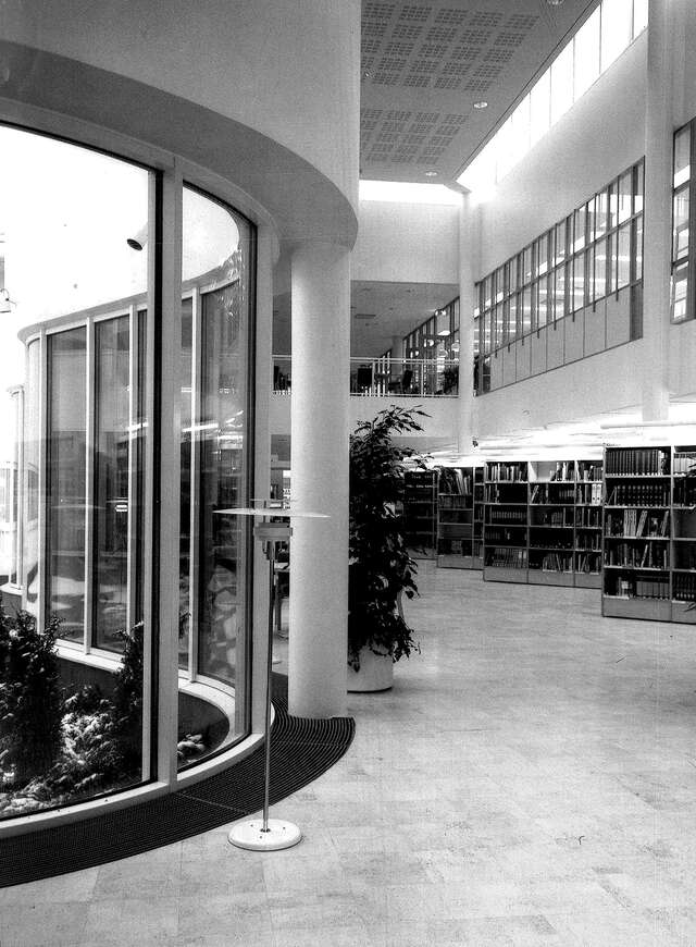 Main hall of a public library, window wall on the left