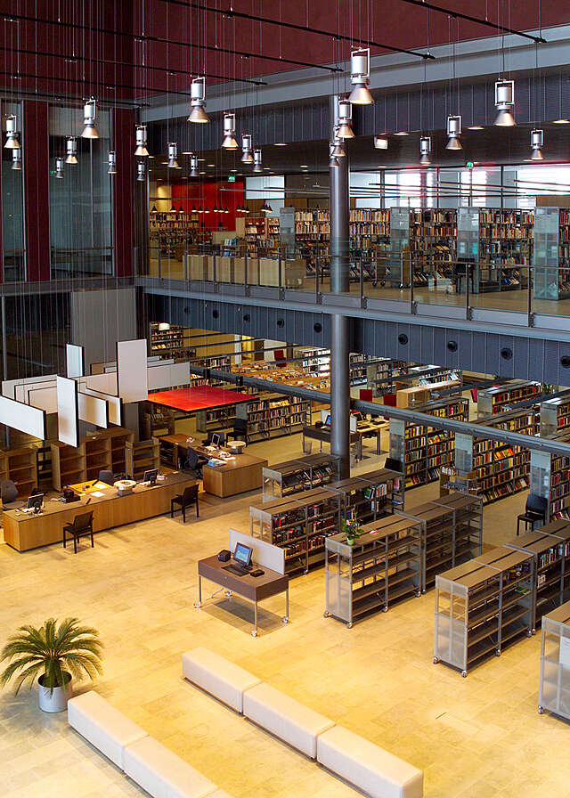 Library bookshelves and information desk viewed from the second floor.