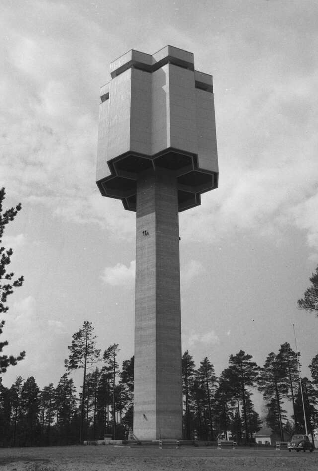 Water tower in brutalist style building has a honeycomb-shaped hexagon distributor reservoir.