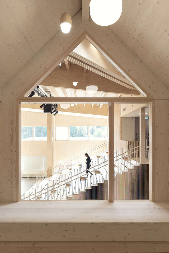Staircase as seen through a window. One person walking on the stairs.