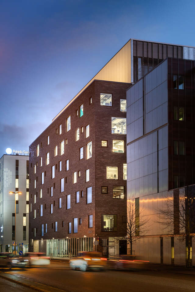 A brown brick building on a busy city street