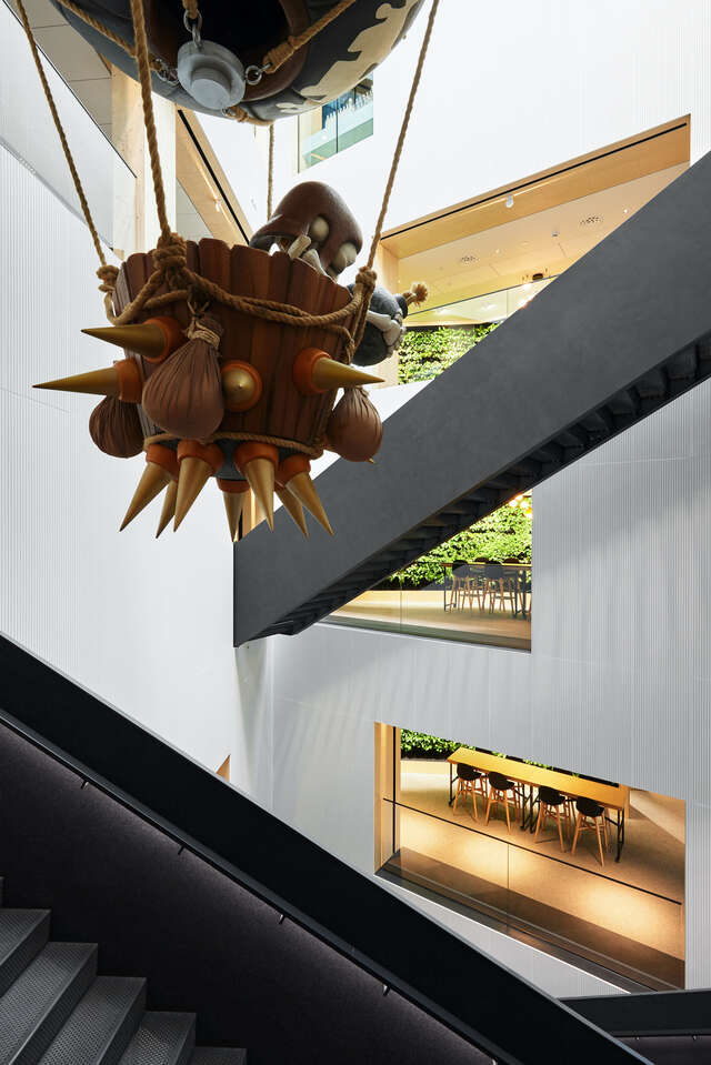 Staircase with hanging decorative wooden artwork in foreground