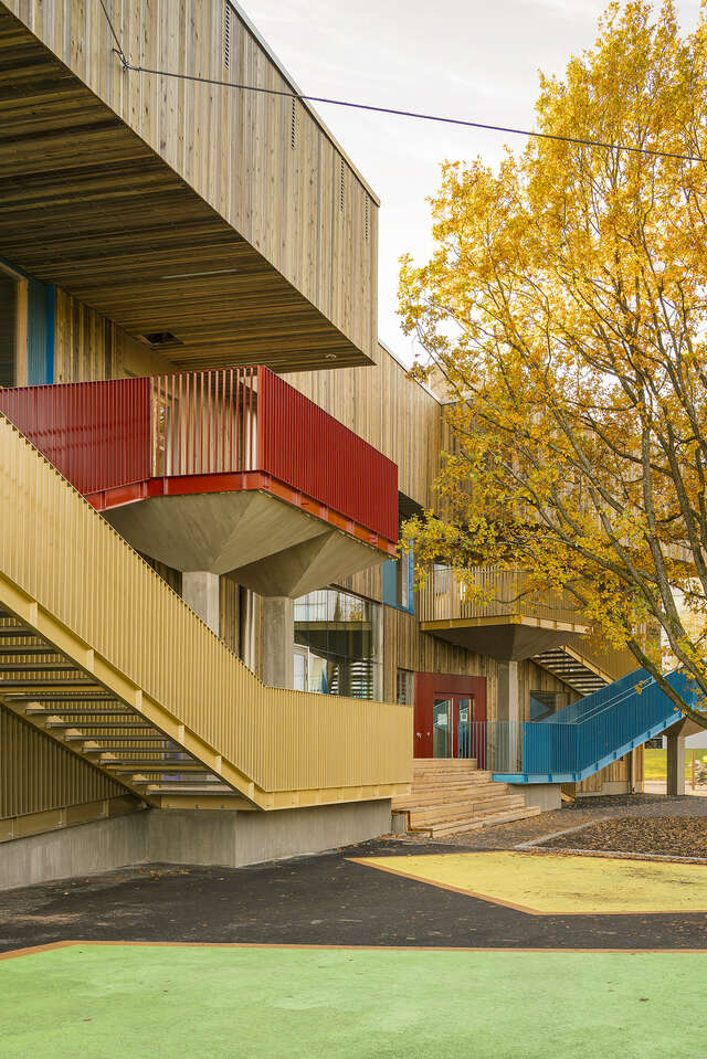 Wooden building with colored staircases on the walls.