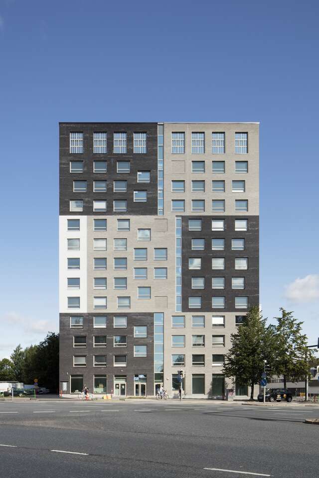 A large apartment building wall with square windows