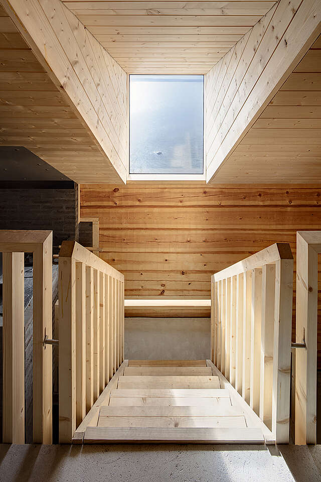 Stairs and a window outside, the ocean is visible.