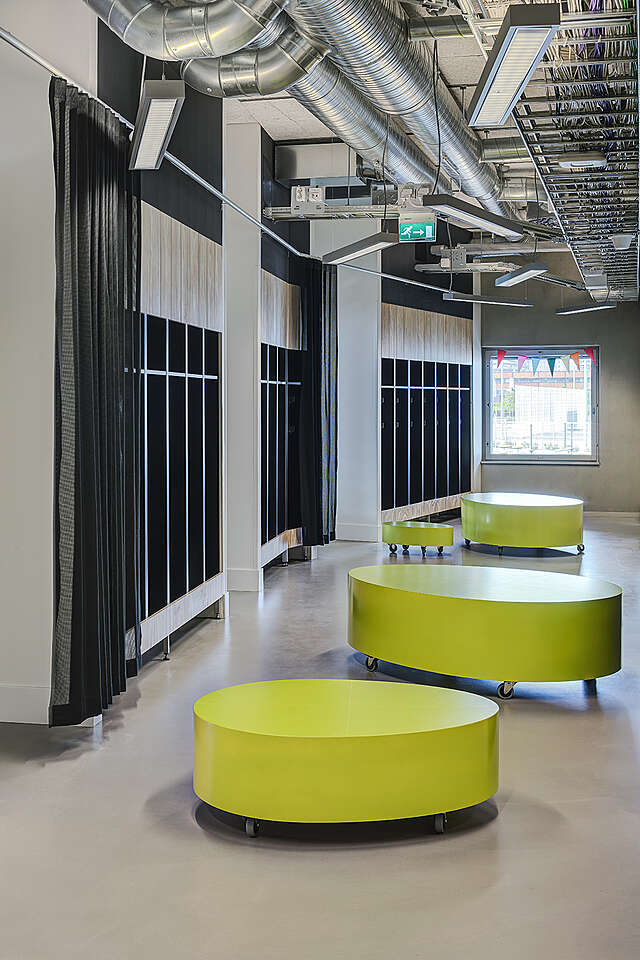 Lime green benches in front of the wardrobe.