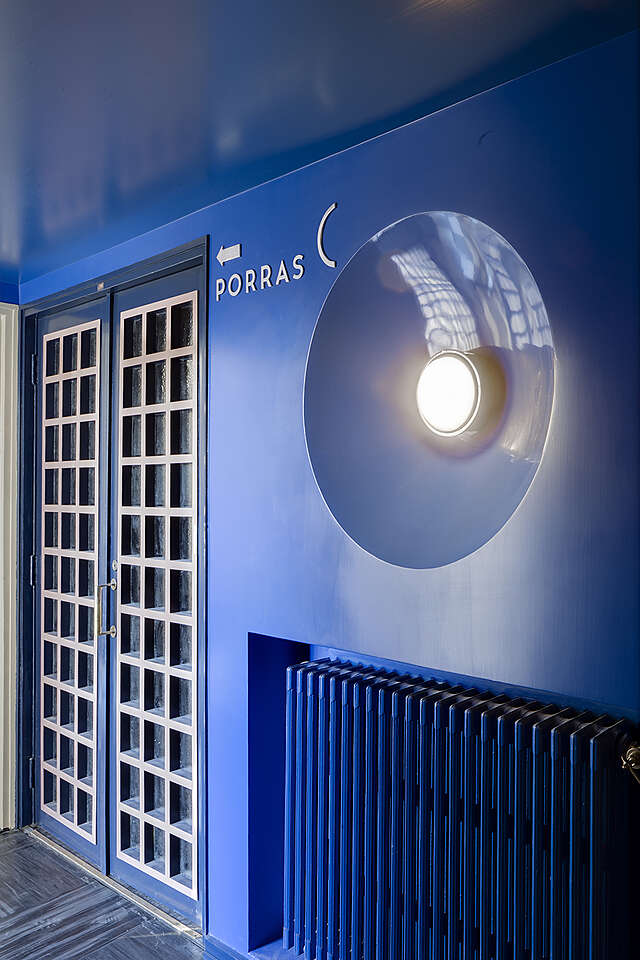 Blue wall with a lamp.