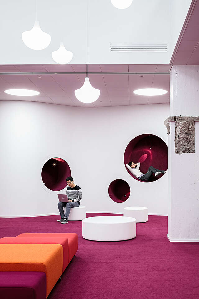 Pink reading nook within the wall.
