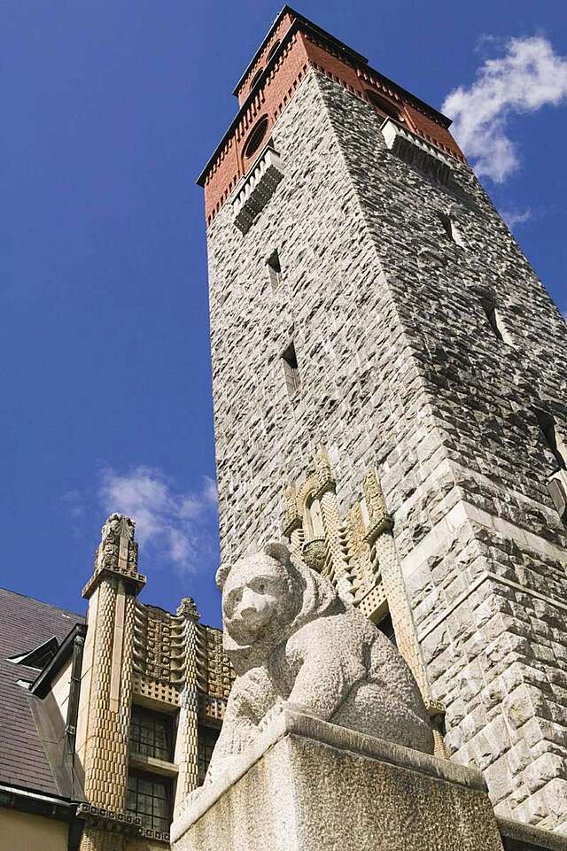 Bear sculpture in the front of the rising granite tower