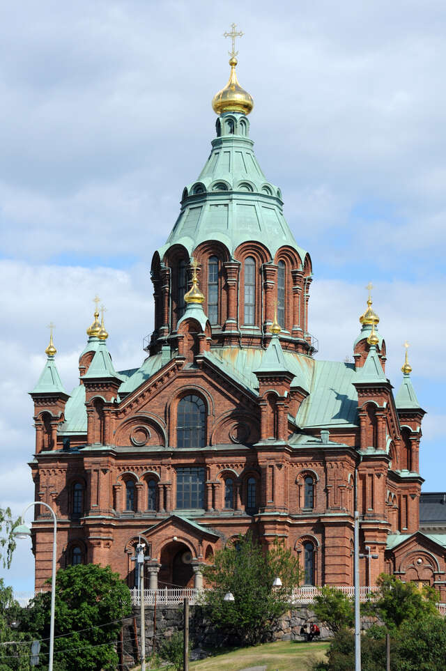 Red-brick church with patina roofs and golden domes