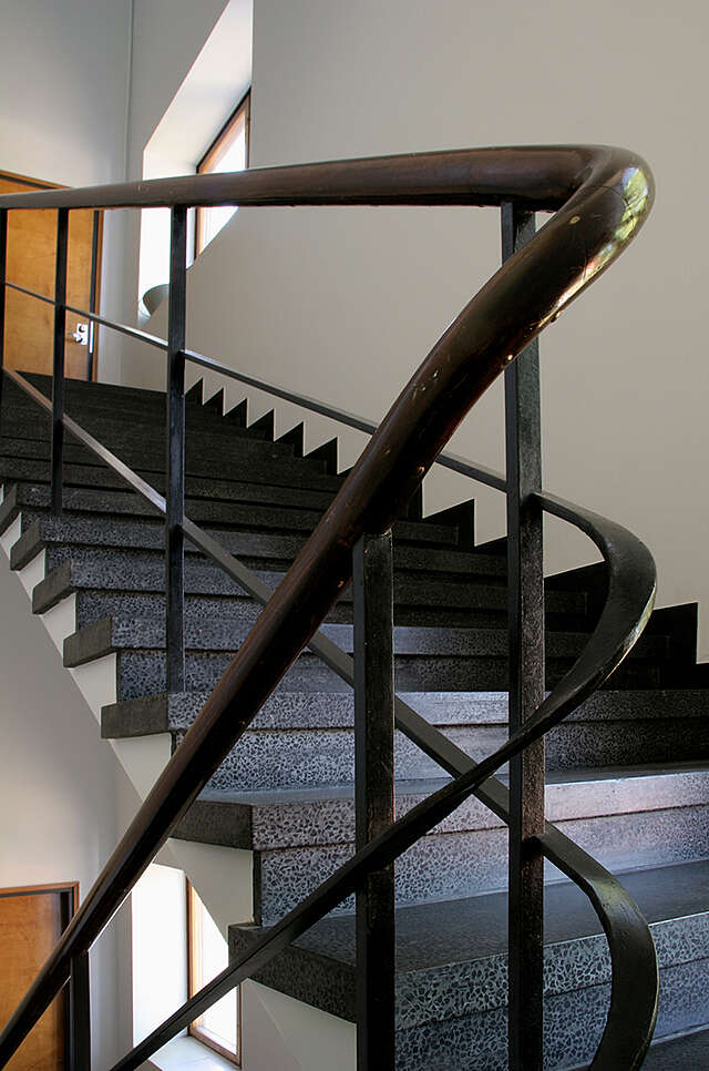 Old metal railing in a stairway.