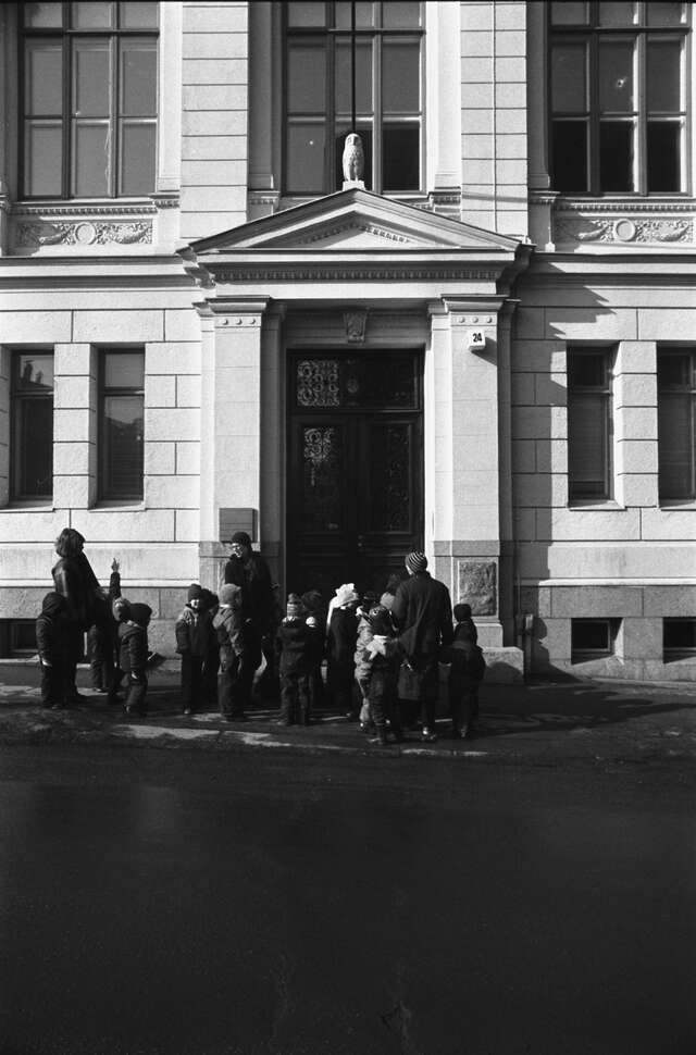 Children and adults standing in front of a door